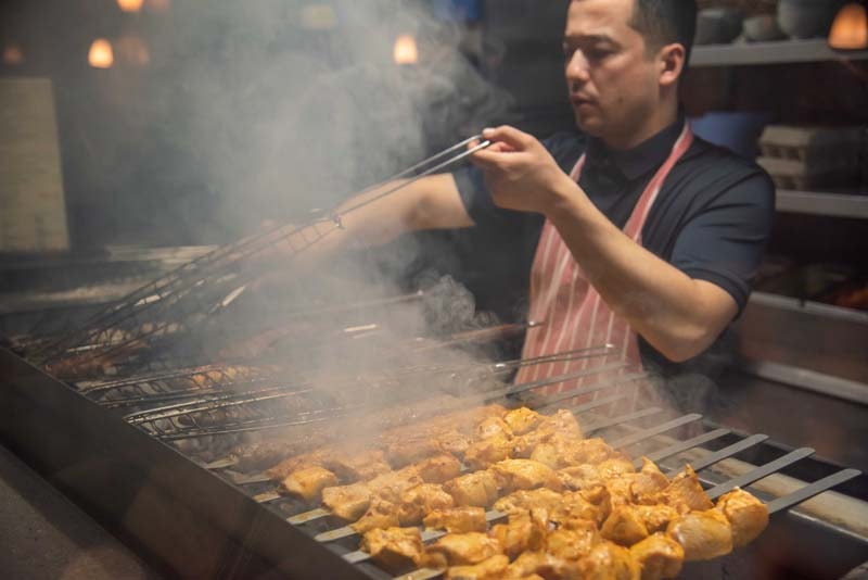 Chef grilling on the charcoal grill