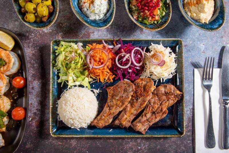 Grilled meat with rice and salads